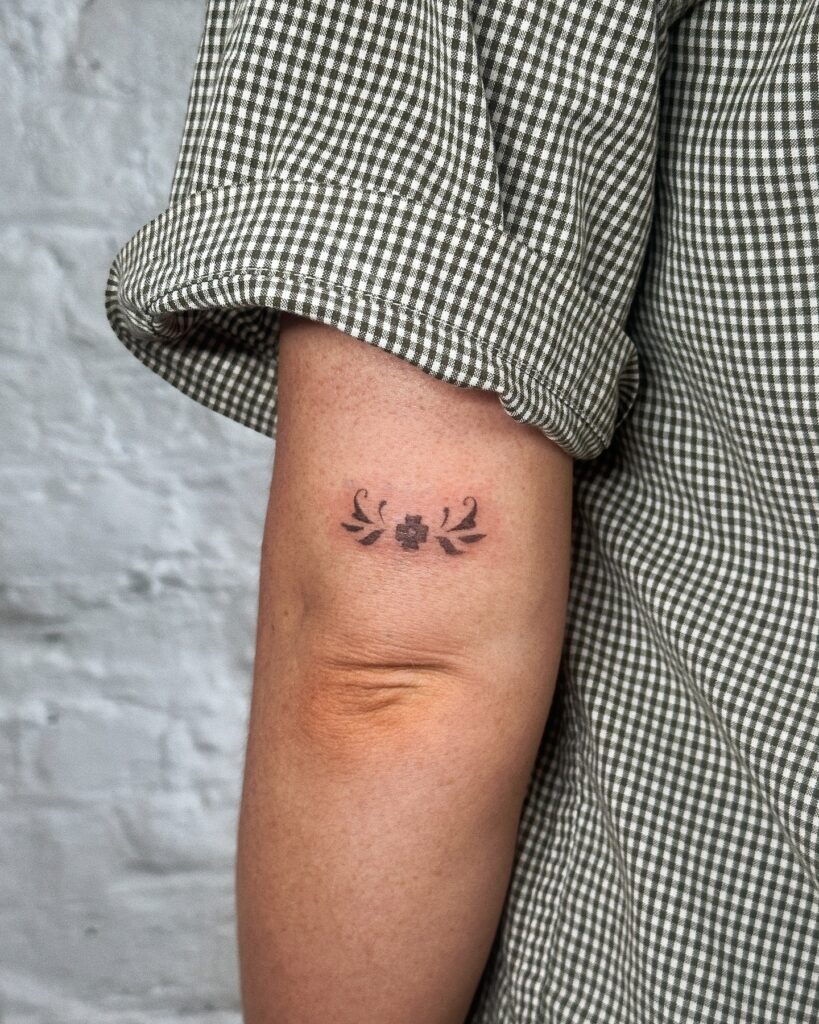 Bold Floral Emblem Stick and Poke Tattoo Tattoo Design