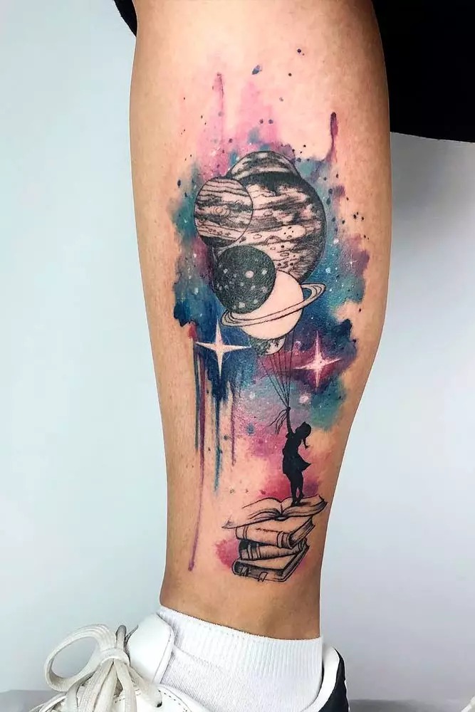 A stunning depiction of outer space, this tattoo combines celestial bodies like planets with the, nebulous qualities of a watercolor background.