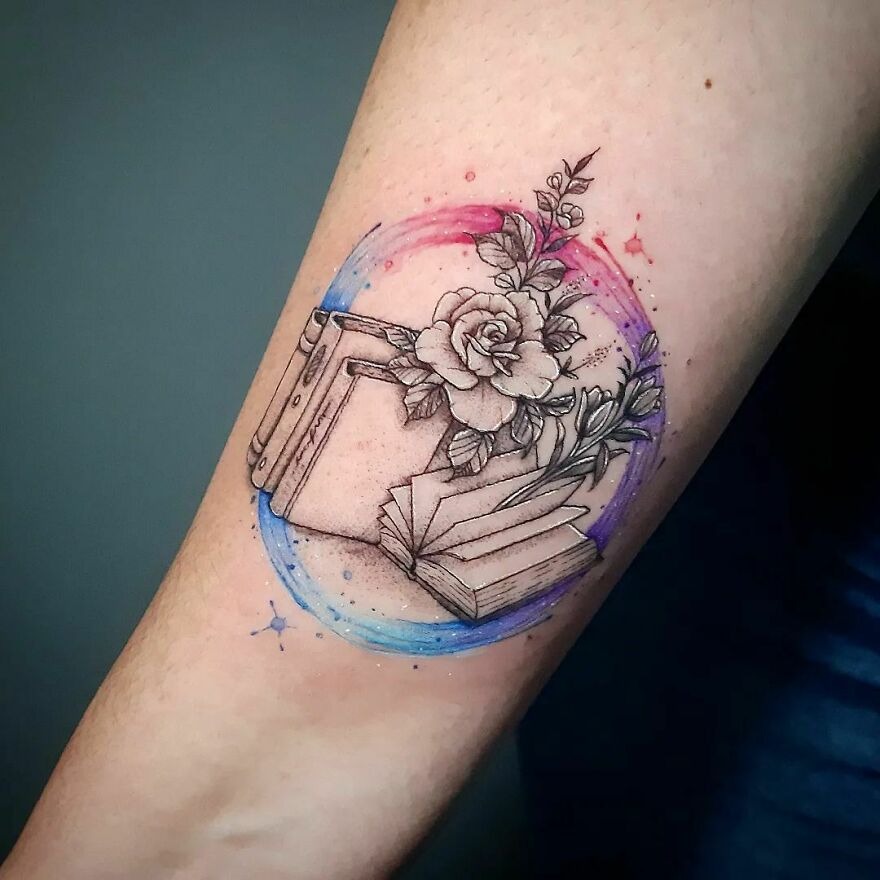 This piece features an open book enveloped by a circle of watercolor splashes and adorned with blooming roses.