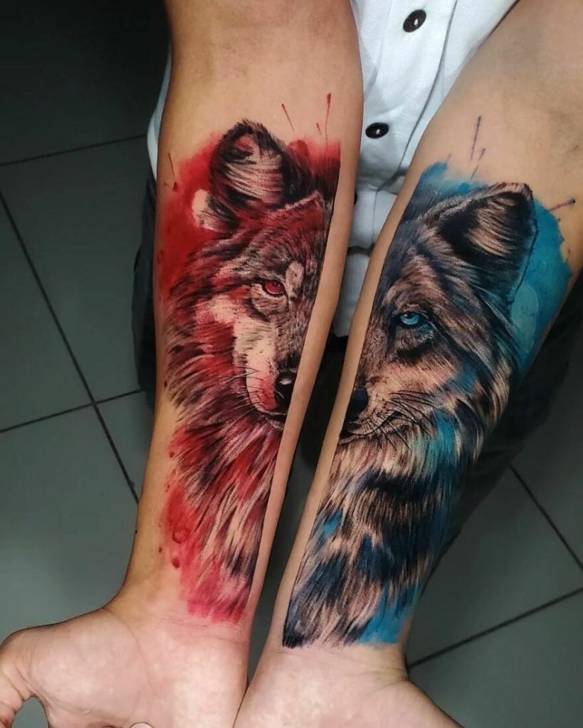 A pair of wolves is captured in contrasting watercolors, one in fiery reds and the other in tranquil blues, symbolizing the dual nature of existence, passion and calmness, aggression and serenity.