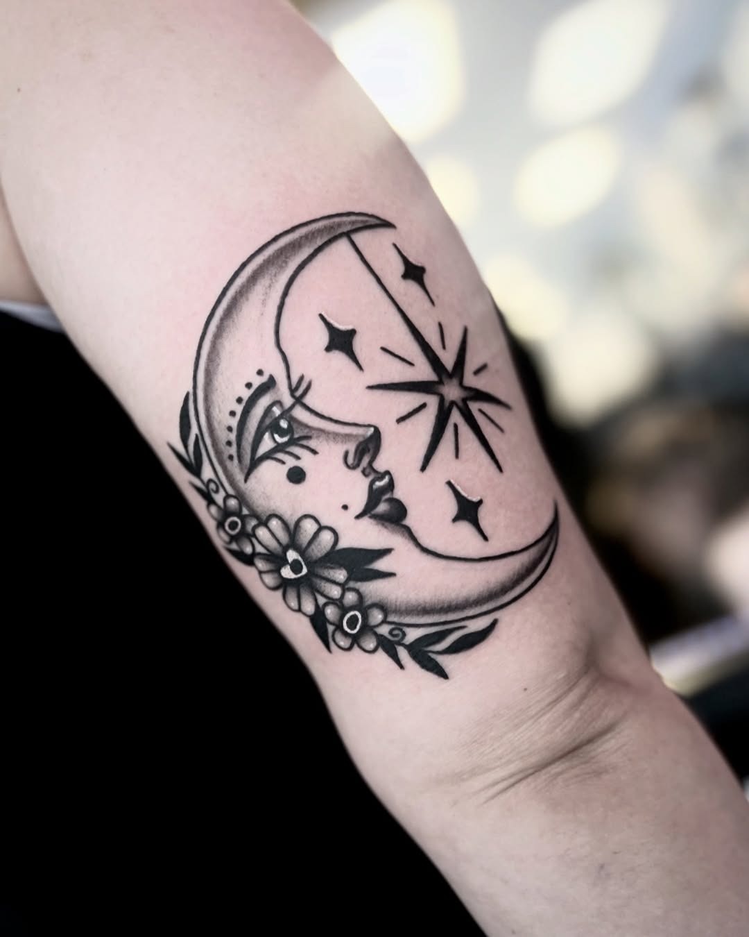 Elegant crescent moon face with floral accents Tattoo Design