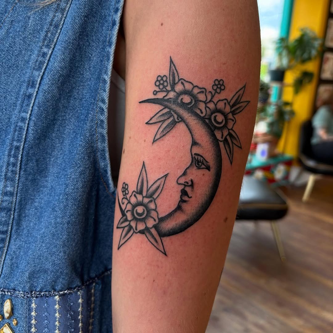 Elegant crescent moon tattoo adorned with flowers Tattoo Design