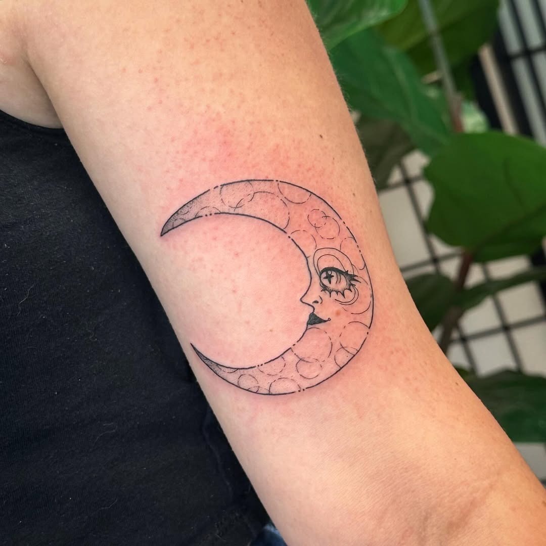 Elegant crescent moon with a mystical face Tattoo Design