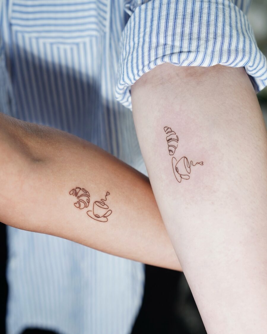 These minimalist croissant tattoos sport sleek lines and subtle details, making them stylish yet understated.