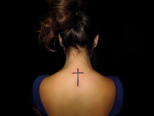 Cute cross tattoo on girl’s back Tattoo Design