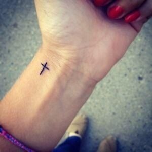 Simple black cross tattoo on a girl’s wrist Tattoo Design