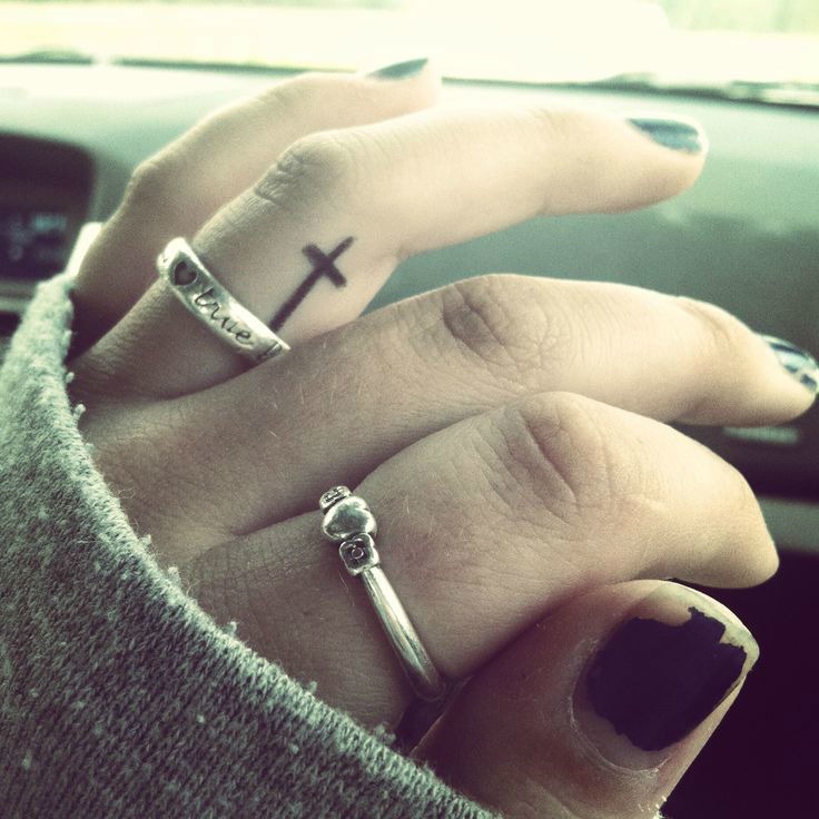 Tiny cross tattoo on girls’ finger Tattoo Design
