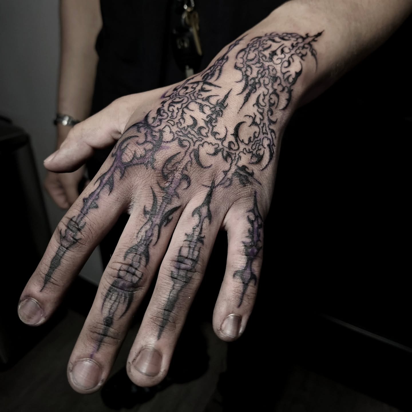 Architectural cybersigilism hand tattoo featuring gothic church arches and barbed knuckles