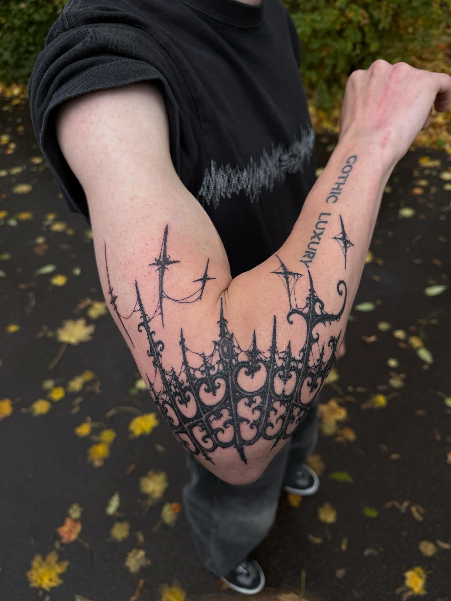 Cybersigilism crown tattoo with pointed architectural spires and thorn jewels on upper neck
