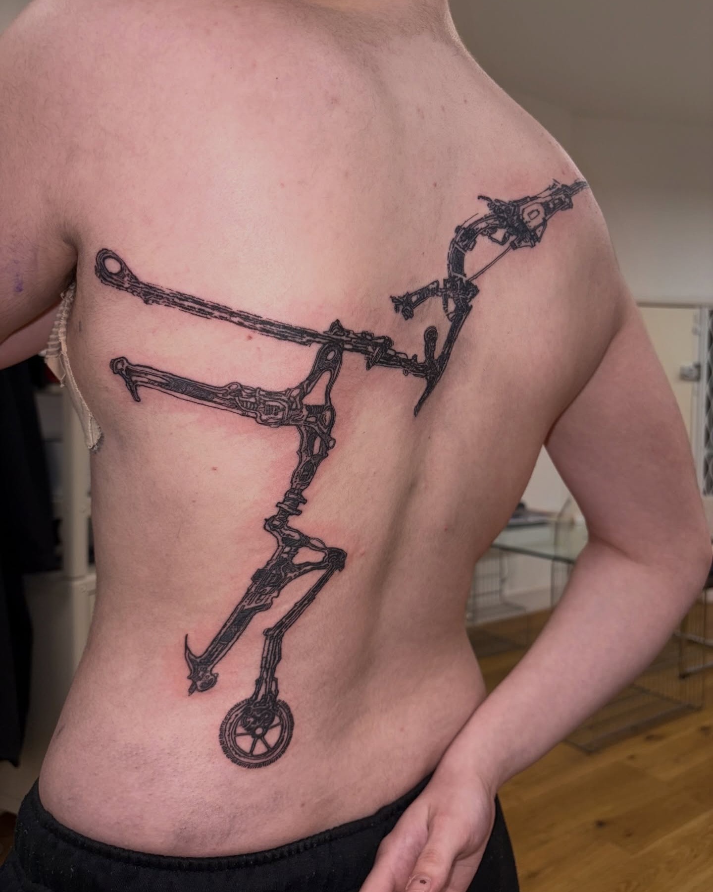 Illustrative mechanical archer tattoo drawing a bow within sharp cybersigilism lines