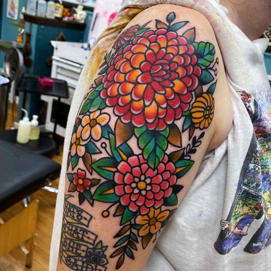 This stunning dahlia tattoo bursts with hues and intricate details.
