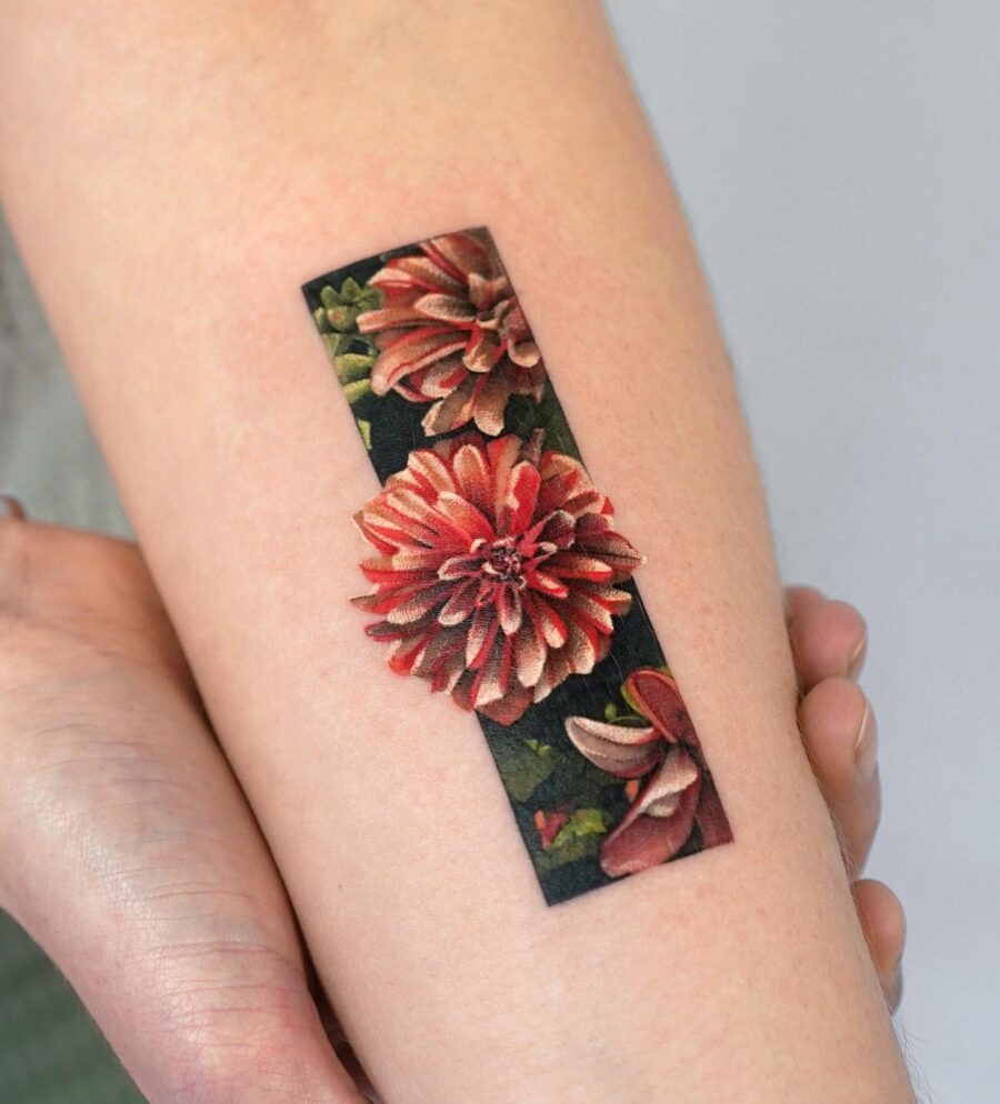 This exquisite dahlia tattoo showcases rich colors and intricate details.