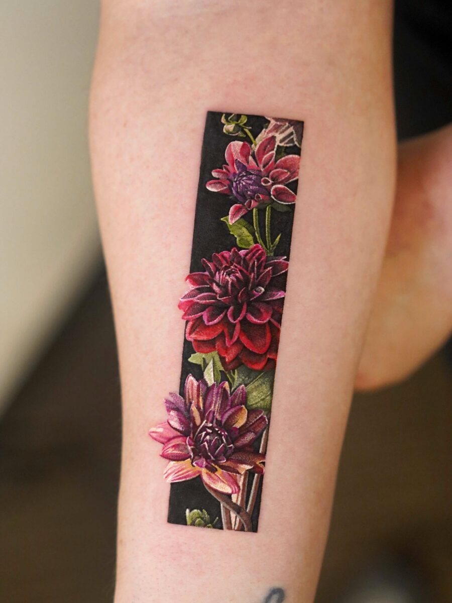 This dahlia tattoo features beautifully detailed blooms with rich colors.