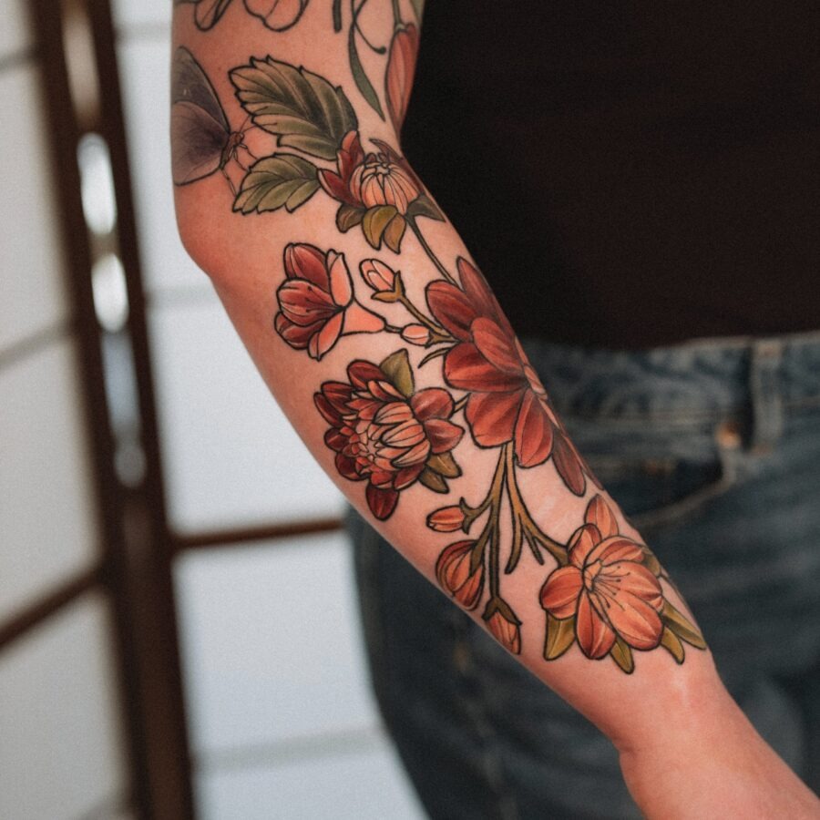 This dahlia tattoo features bold and colors, showing the flower's beauty.