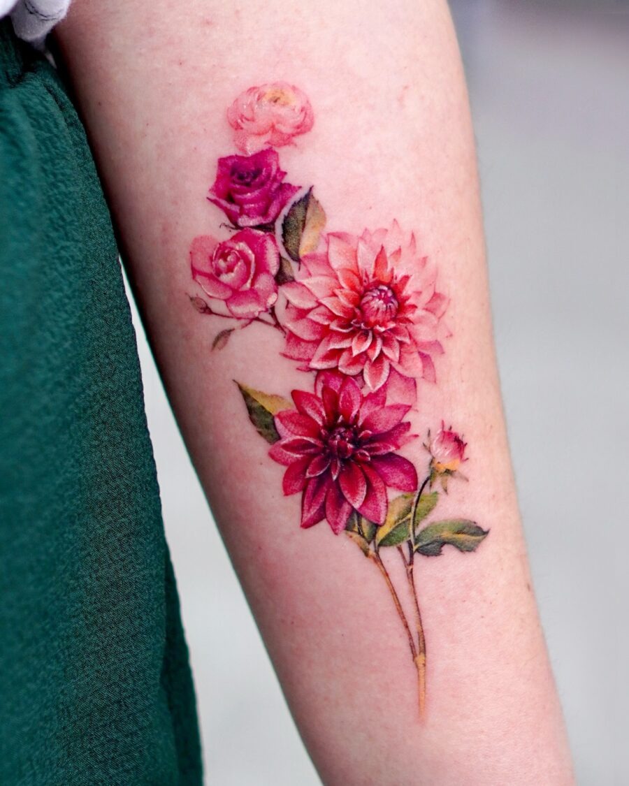 This dahlia tattoo features an array of colors, showing intricate details and floral beauty.
