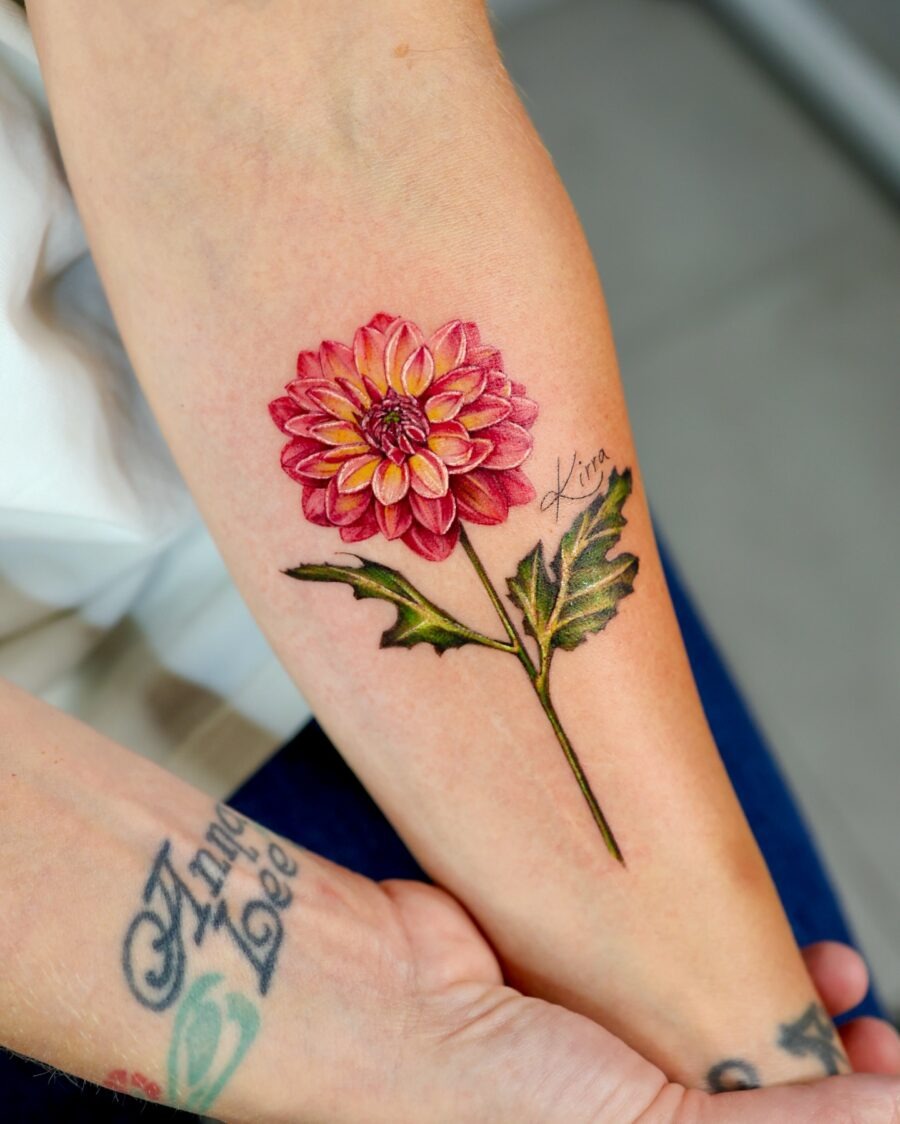 This eye-catching dahlia tattoo captures the flower's vivid beauty with intricate details.