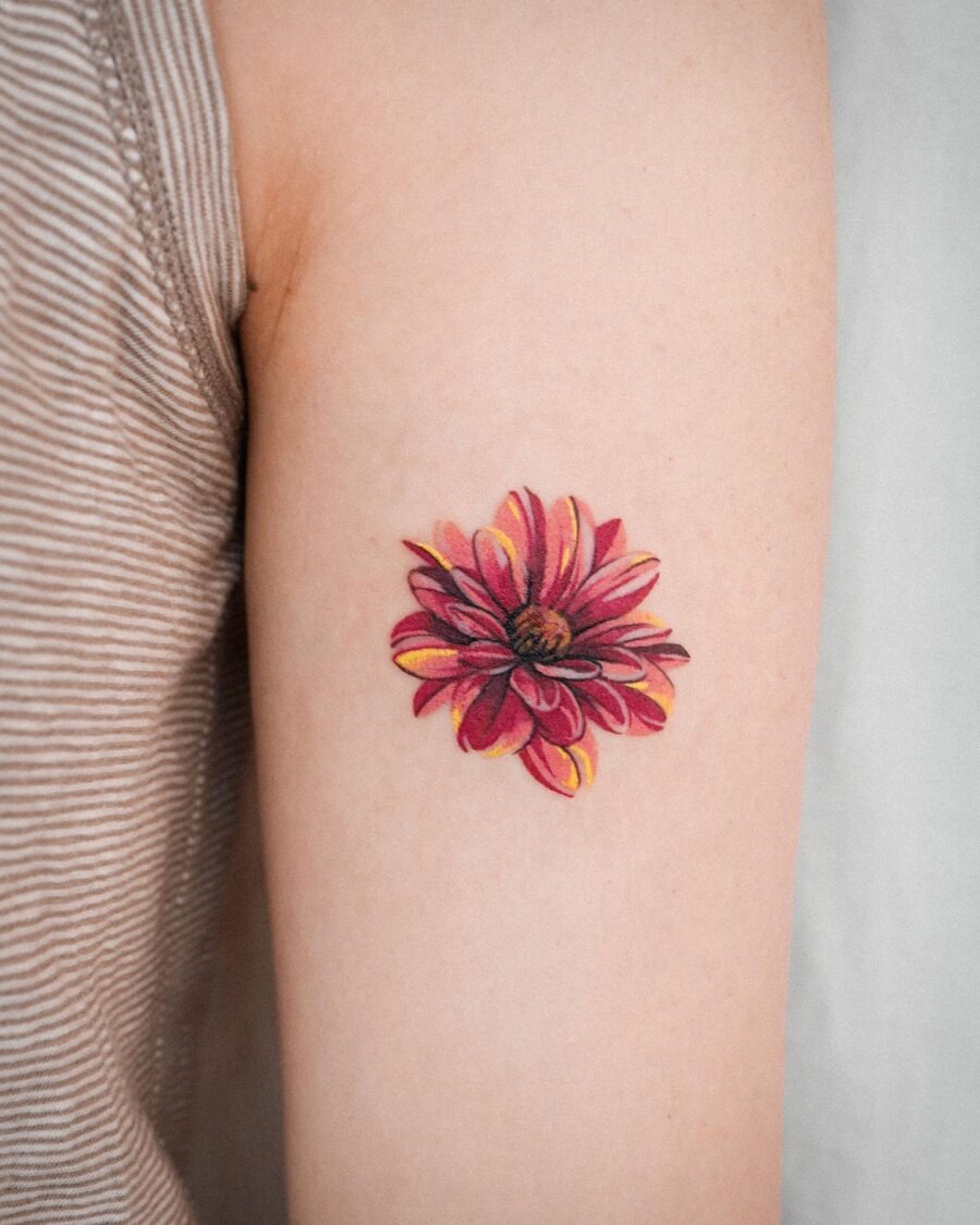 This colorful dahlia tattoo is a beautiful expression of art and nature.