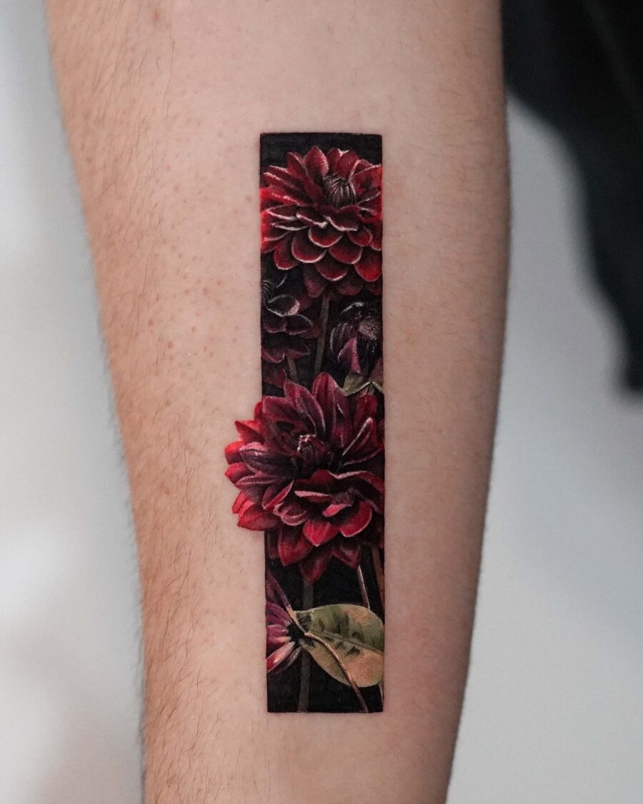 This stunning dahlia tattoo features rich red flowers in striking detail.