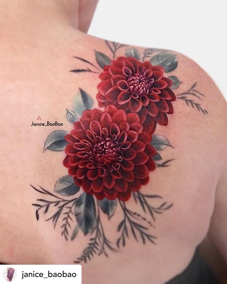 This bold dahlia tattoo showcases intricate details and a beautiful color palette.