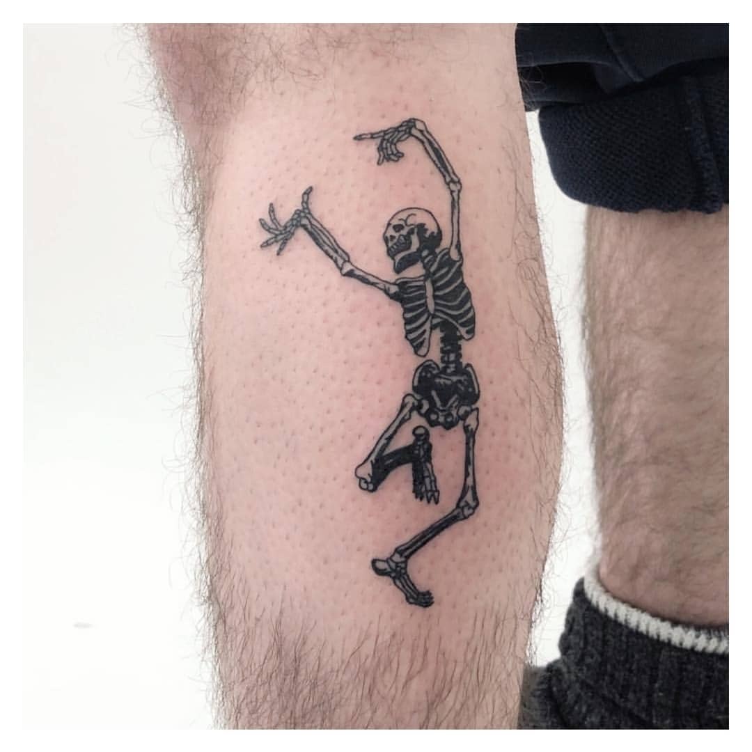 Whimsical skeleton dancing tattoo on leg Tattoo Design