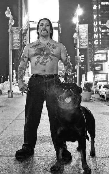 In this nighttime portrait, Trejo walks the city streets with a massive Rottweiler at his side, both exuding power and confidence.