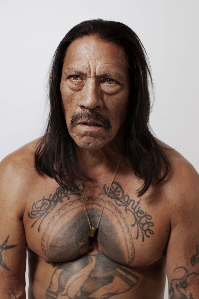 Trejo's rugged appearance is reimagined in this rare portrait, featuring him with long hair and a steely gaze.