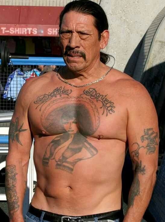 Trejo's chest tattoo shines under the sun in this outdoor capture.