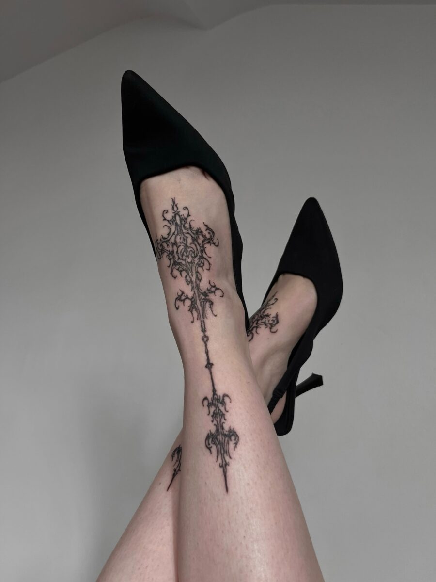 Elegant dark feminine tattoo on leg. Tattoo Design