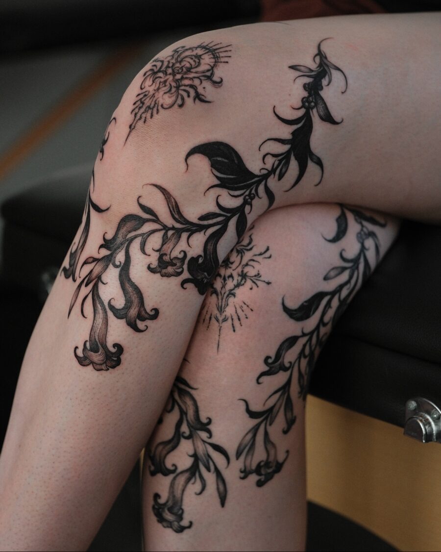 Elegant floral ink designs on feminine legs Tattoo Design