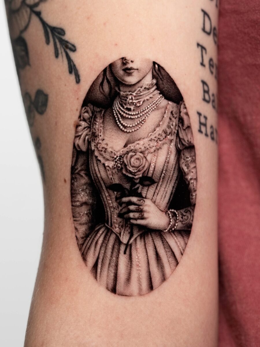 Elegant vintage lady tattoo with floral accents Tattoo Design