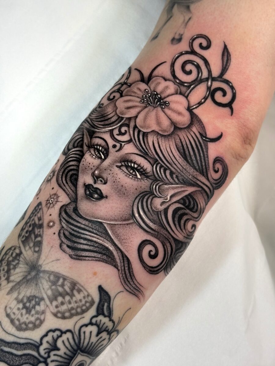 Enchanting elven tattoo with floral details Tattoo Design