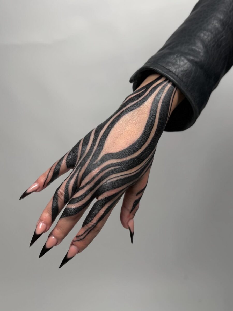 Striking Black Lines on Feminine Hand Tattoo Design