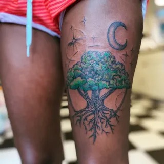 Nature-Inspired Thigh Tattoo with Moon and Stars Tattoo Design