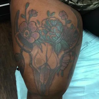 Skull and Floral Combination on the Thigh Tattoo Design