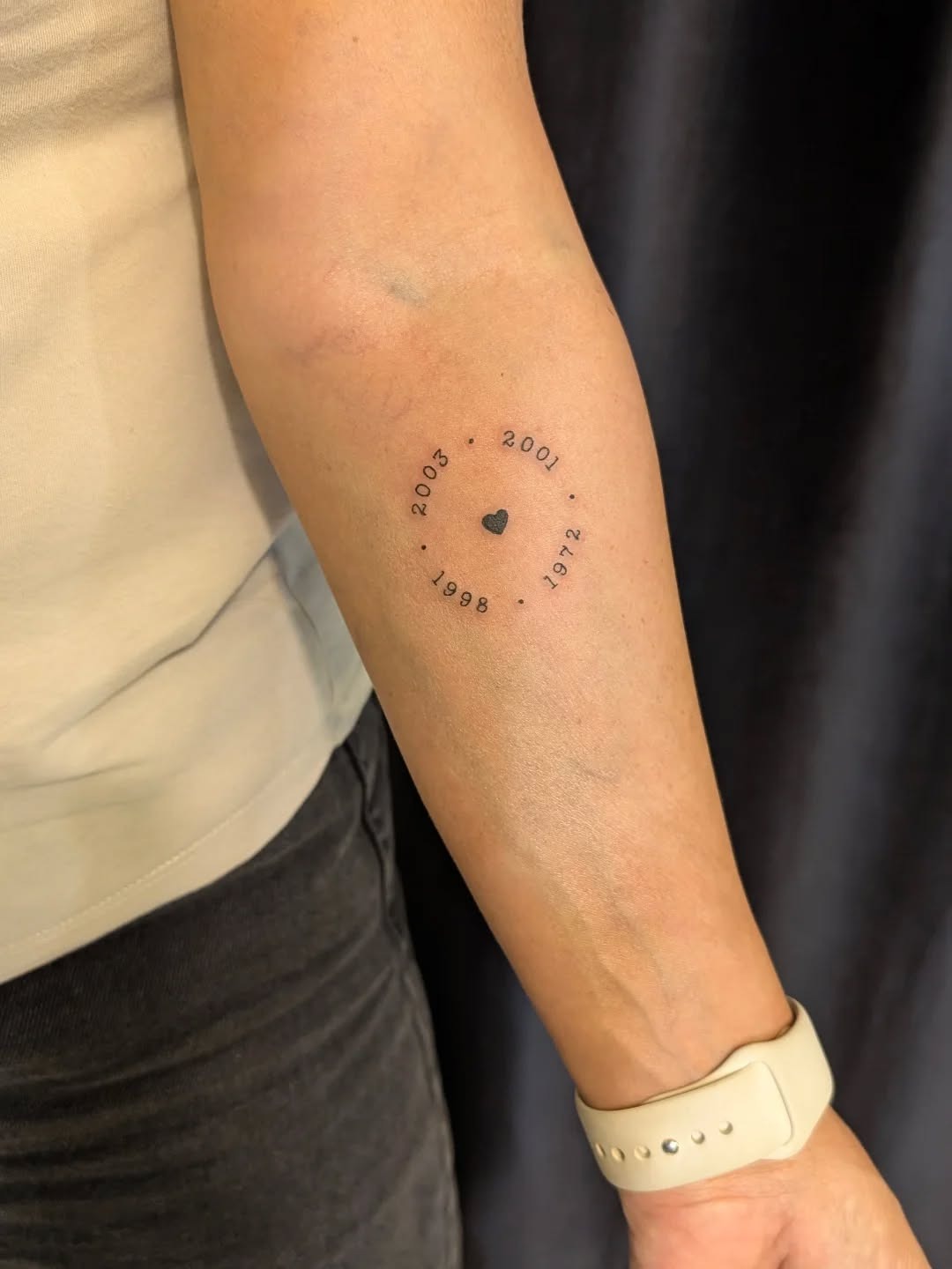 Meaningful circular date tattoo with heart Tattoo Design