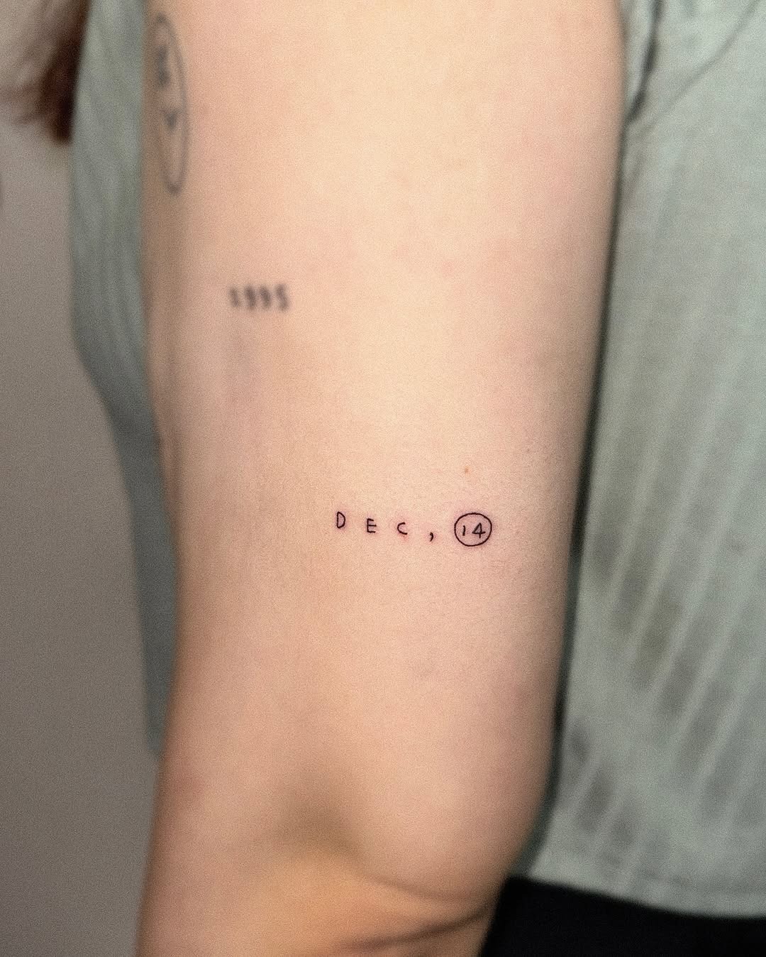Minimalist Date Tattoo on Upper Arm Tattoo Design