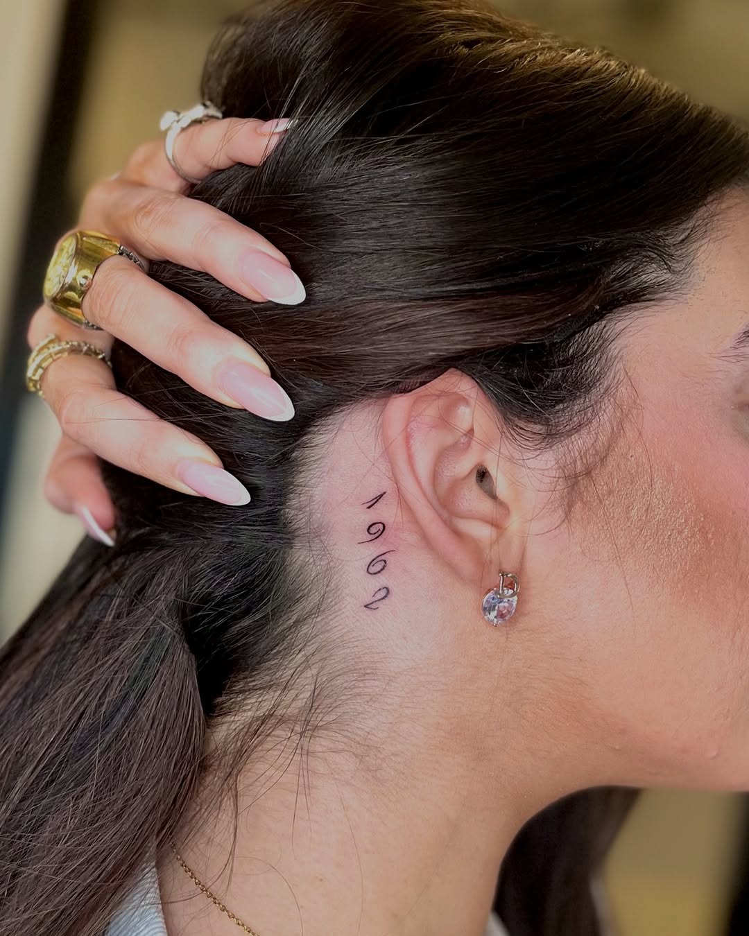 Unique Date Tattoo Displayed Behind Ear Tattoo Design