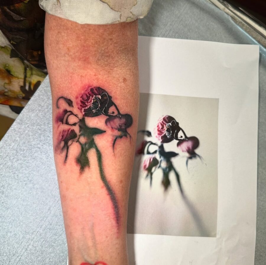 Elegantly decayed floral tattoo on the arm Tattoo Design