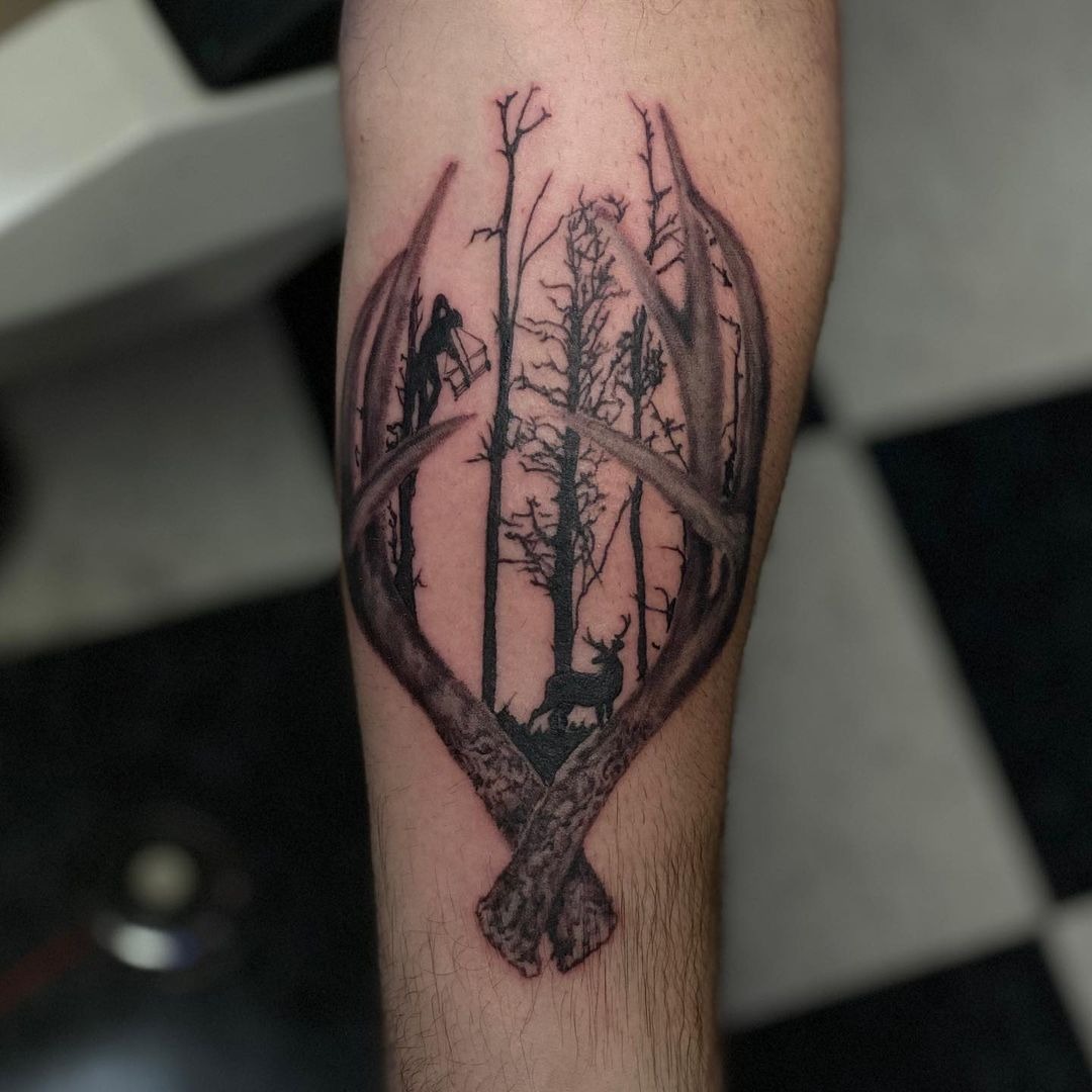 Antlers with Hidden Forest Scene, a tattoo design rendered in clean detailed linework.