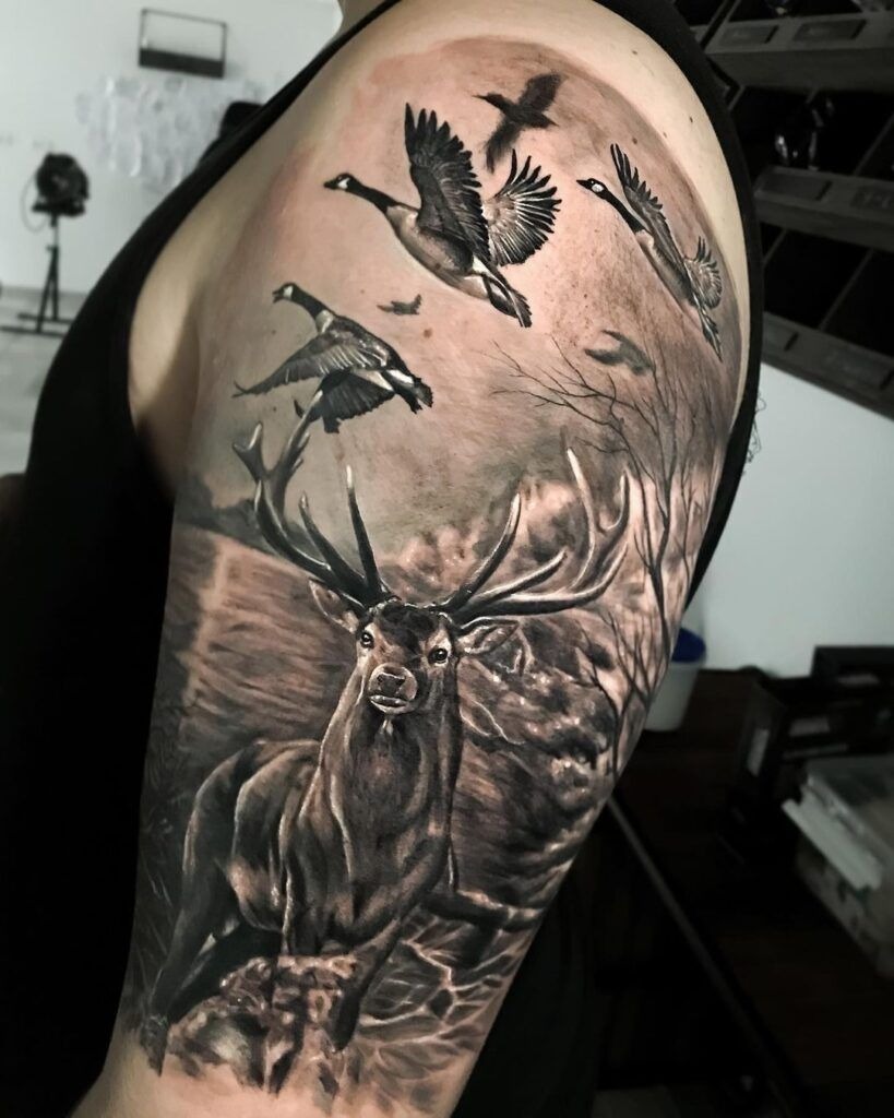 Realistic Deer with Flying Geese, a tattoo design rendered in clean detailed linework.