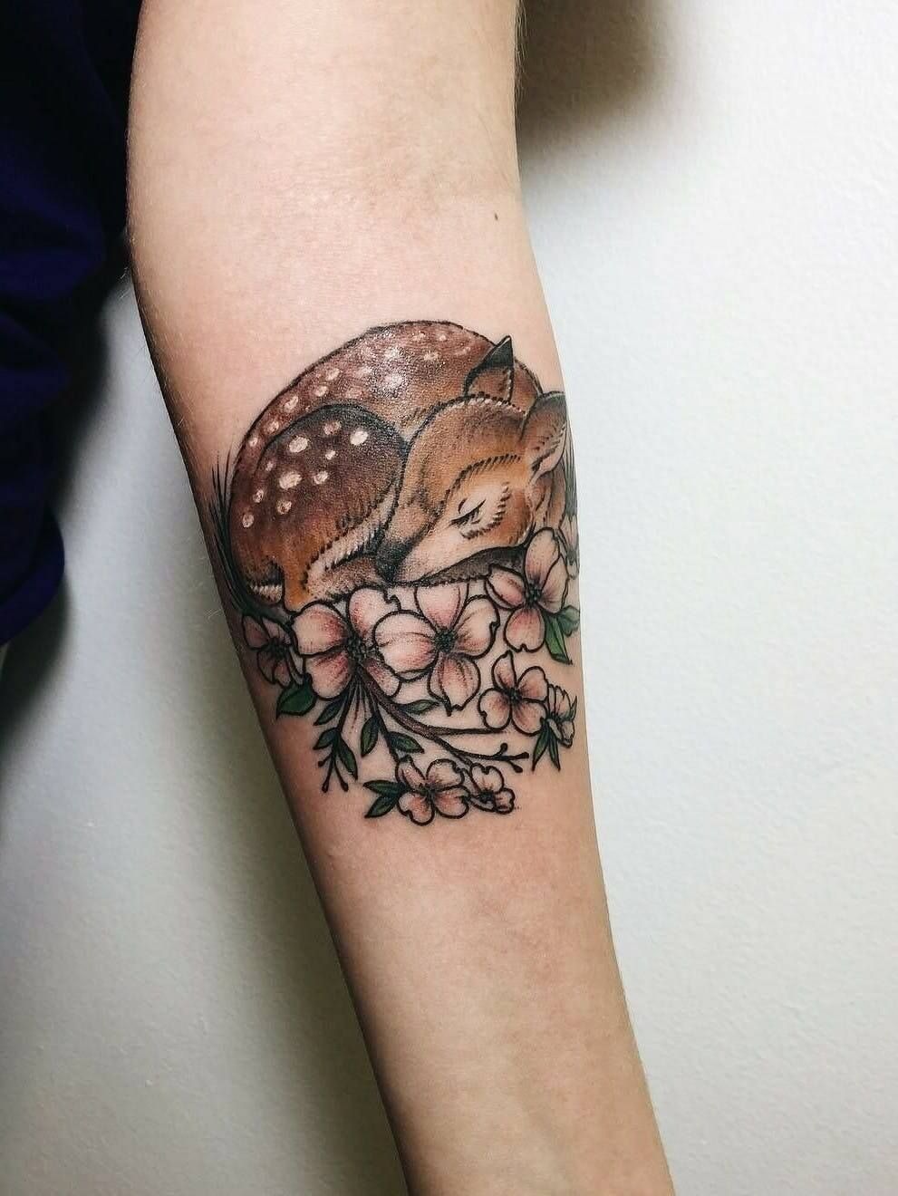 Sleeping Fawn with Blossoms, a tattoo design rendered in clean detailed linework for the arm.