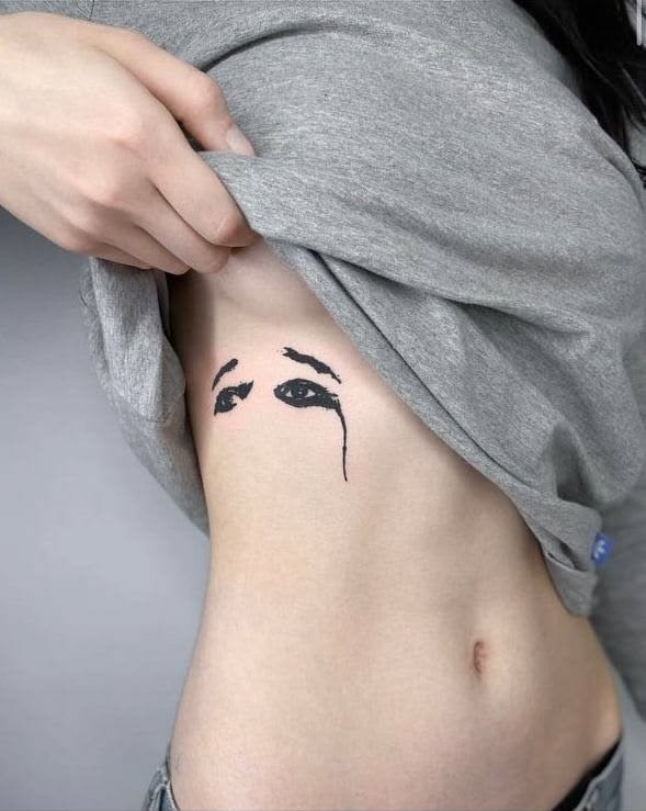 Rib Placement Crying Eyes with Soft Grunge Edge Tattoo Design