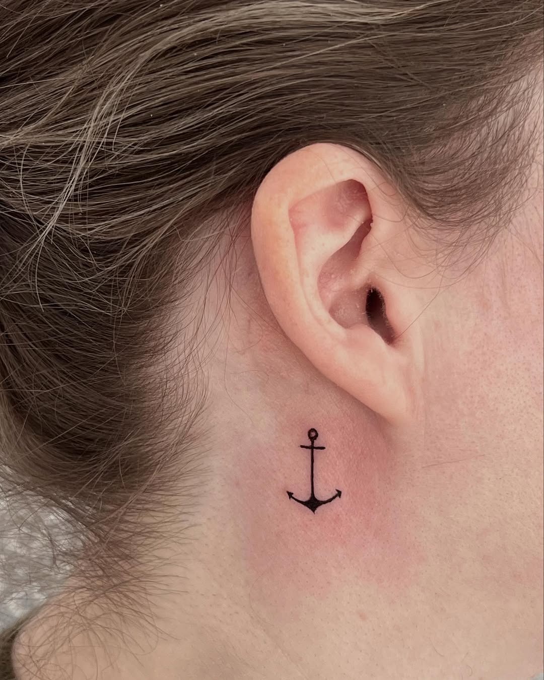 Sleek anchor tattoo behind the ear Tattoo Design