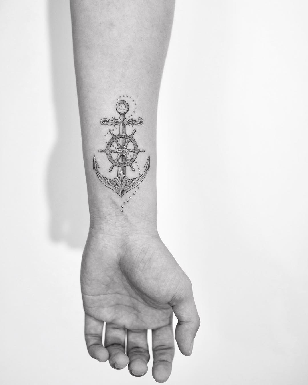Stylish anchor and wheel tattoo on forearm Tattoo Design