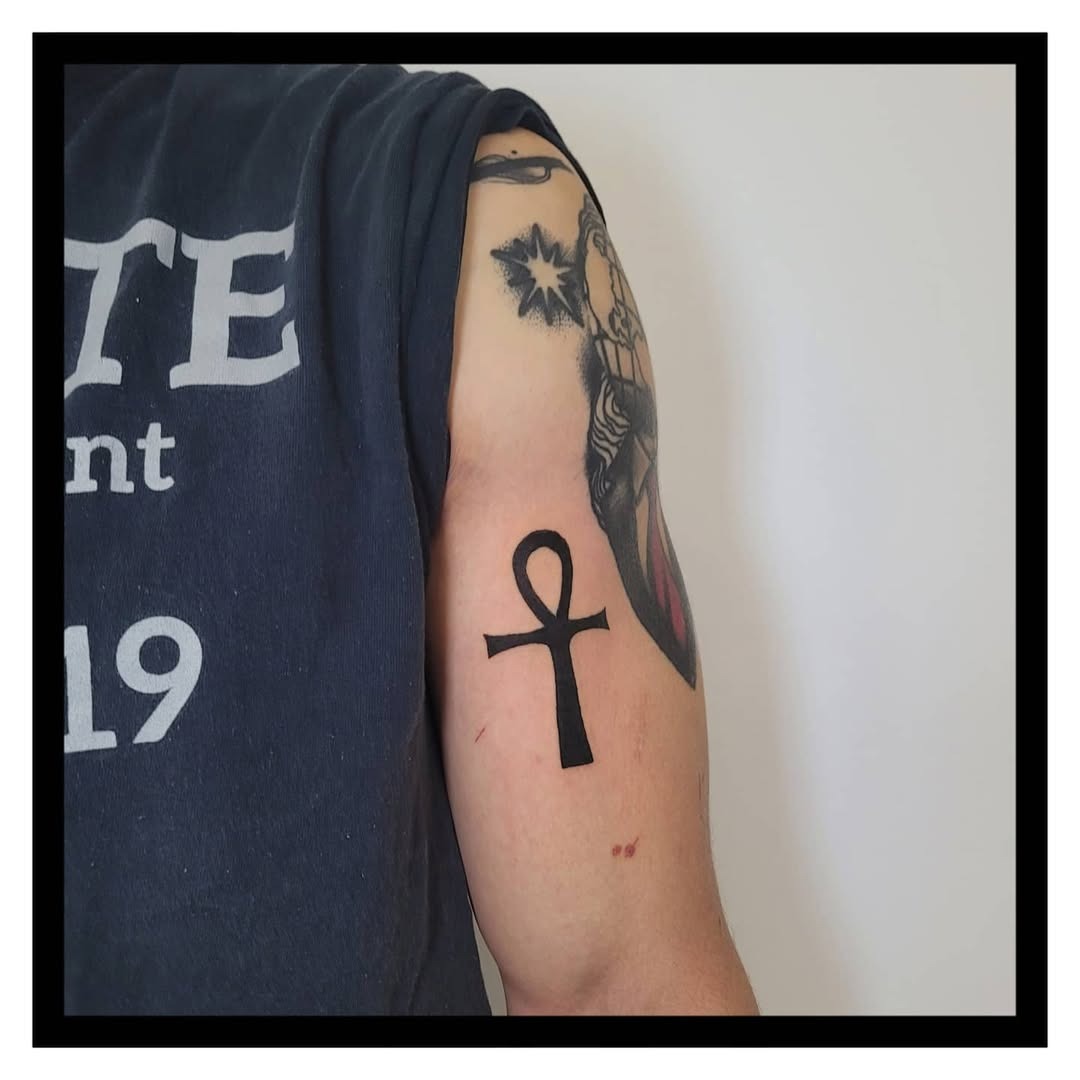 Stylish ankh tattoo in bold black ink Tattoo Design
