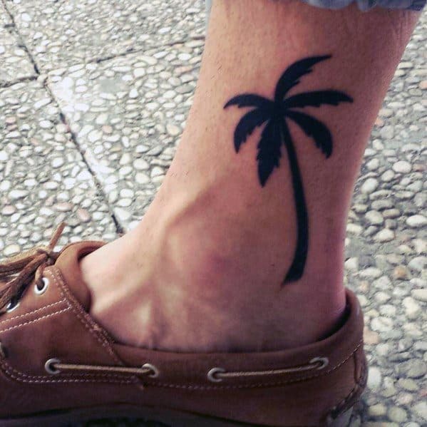 Ankle Tattoo Idea: Black Palm Tree Growing From Ankle Tattoo Design