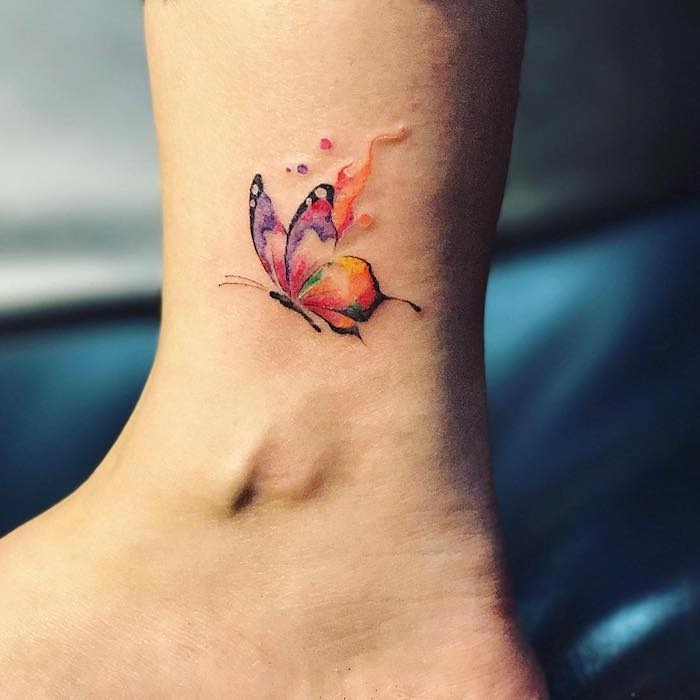 Small Butterfly Ankle Tattoo with Splashes of Color Tattoo Design