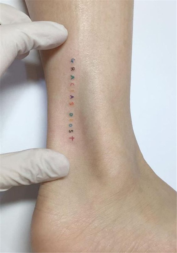 Tiny Vertical Multicolored Letters and Cross Tattoo Design