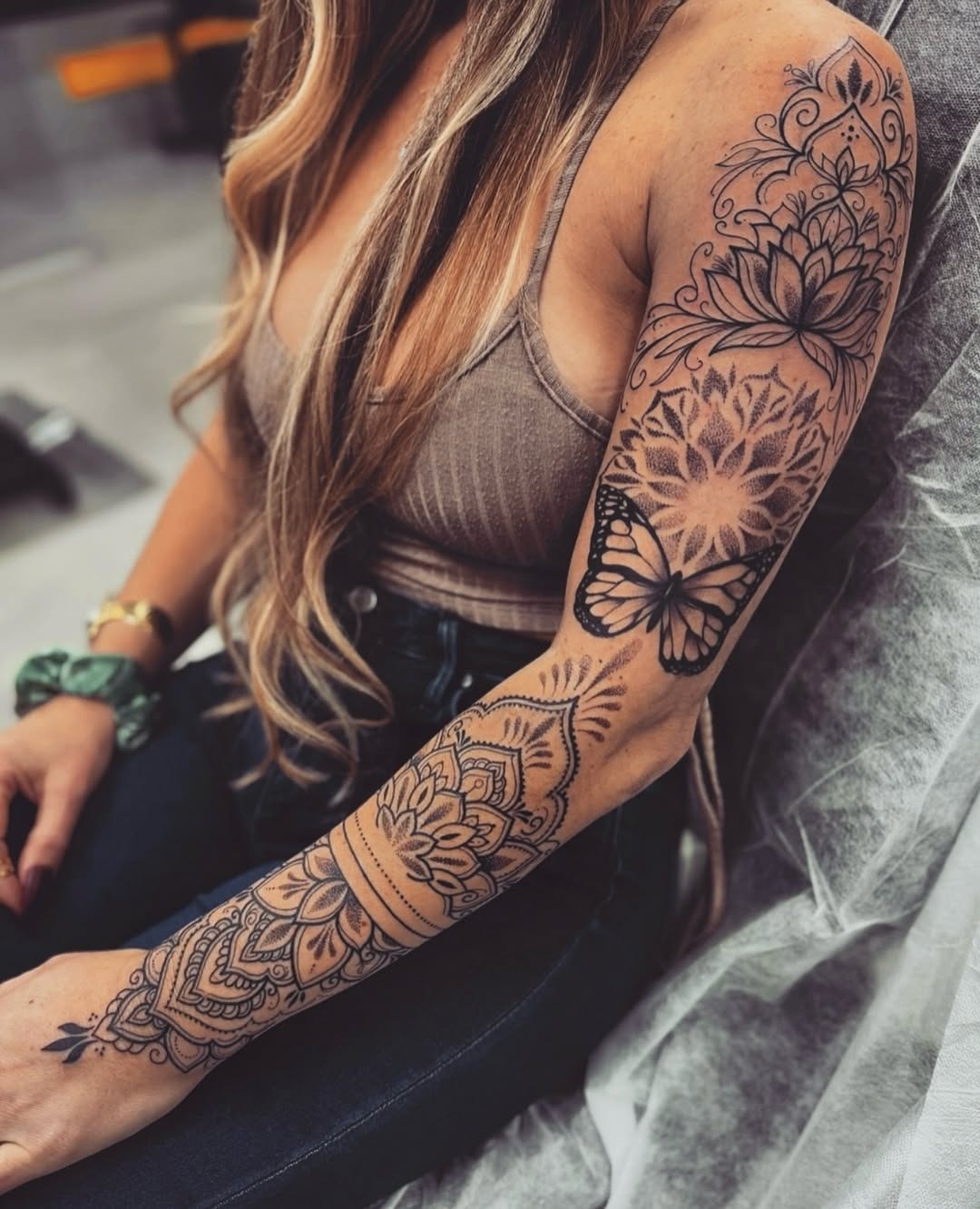 Elegant arm tattoos with floral and butterfly motifs Tattoo Design