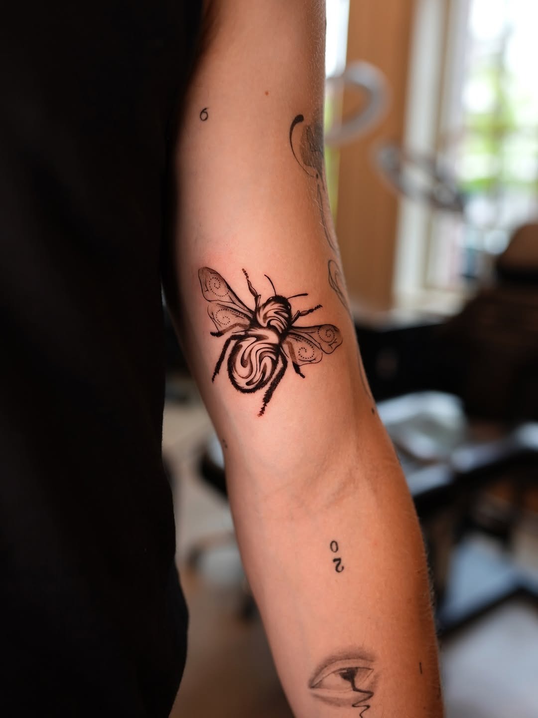 Elegant bee tattoo design on woman’s arm Tattoo Design